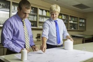 Drug Plastics representative showing a bottle drawing to a customer