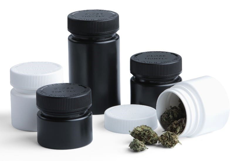 Black and white plastic bottles with cannabis product falling out